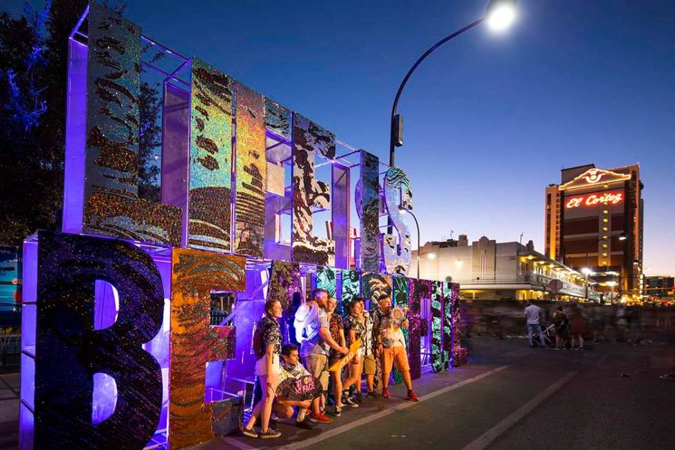 Festivalgoers pose next to a Life is Beautiful sign at the annual festival in downtown Las Vega ...