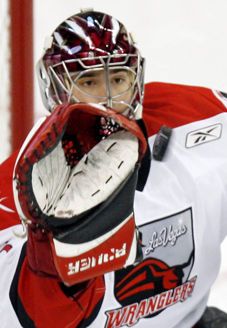 Las Vegas Wranglers goalie Mike McKenna stops a shot from a Victoria Salmon Kings player during ...