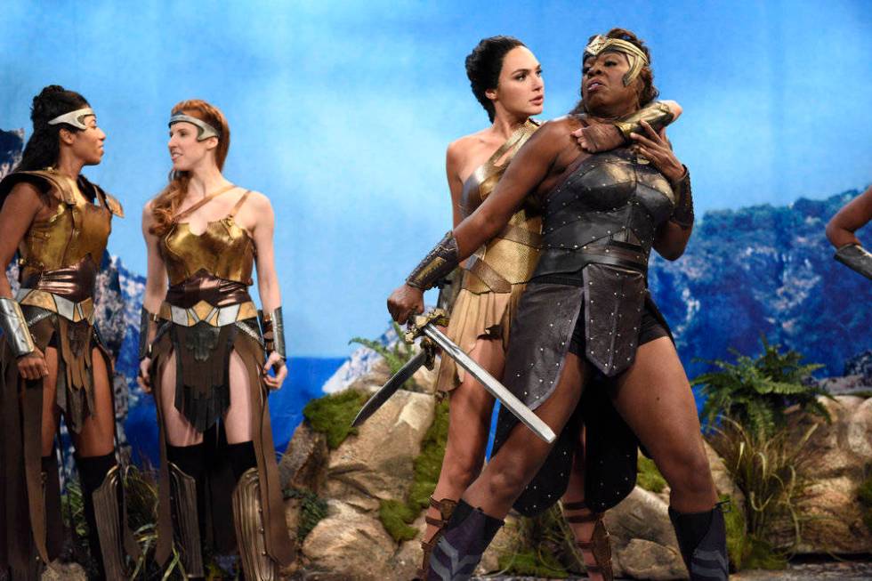 This image released by NBC shows Gal Gadot, center, and Leslie Jones, right during a sketch on ...