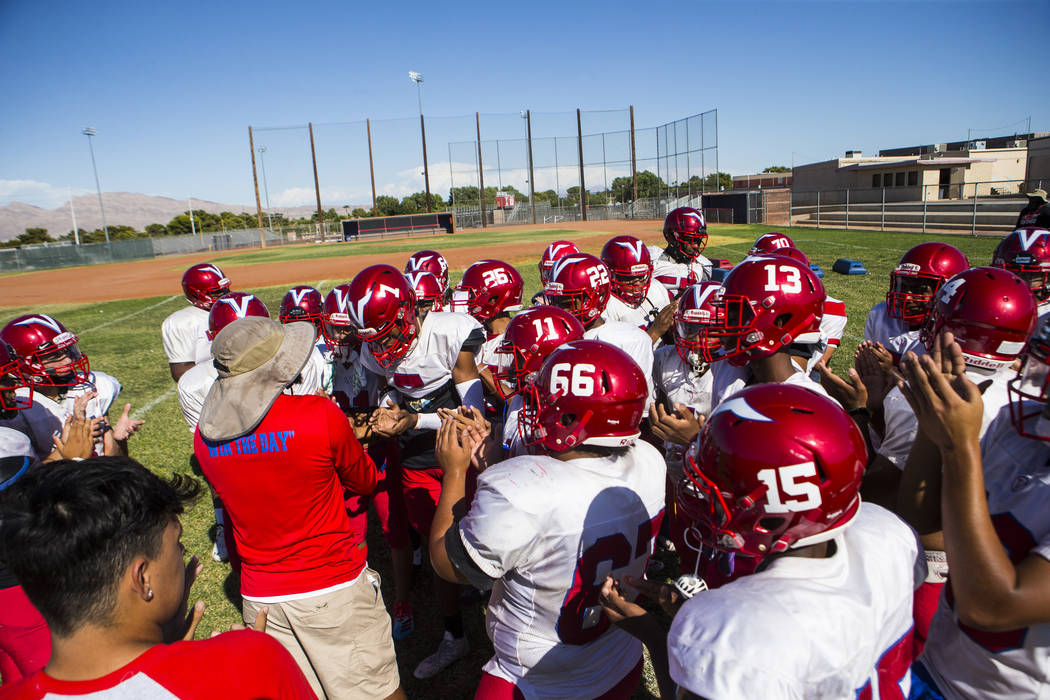 Valley coach Quincy Burts, left, leads football practice at the baseball field at Valley High S ...