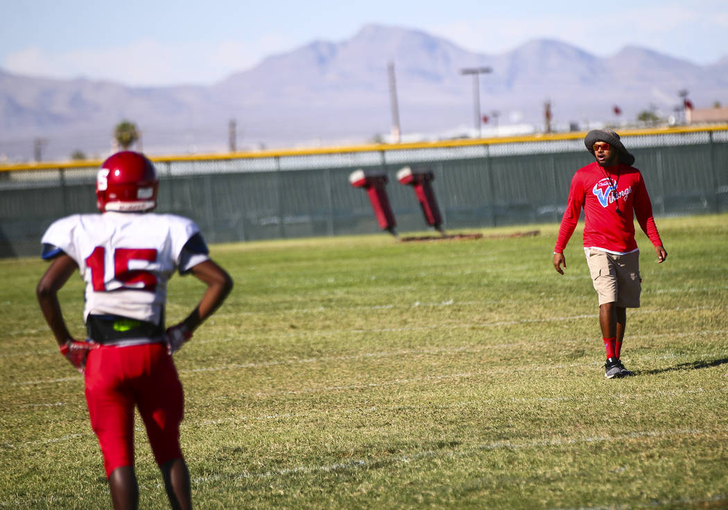 Valley coach Quincy Burts, right, leads football practice at the baseball field at Valley High ...