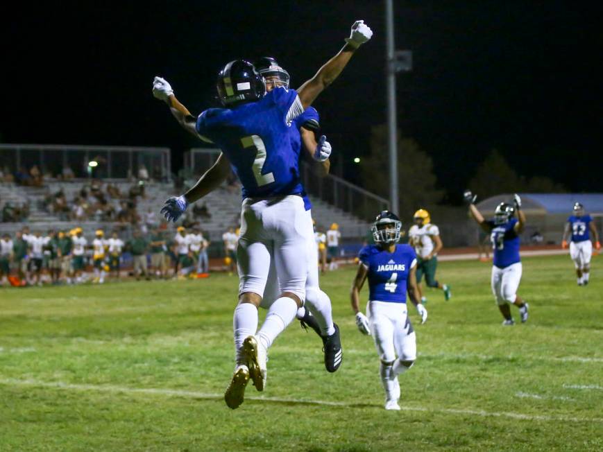 Desert Pines' Deandre Moore (2) celebrates his interception with Michael Jackson lll during the ...