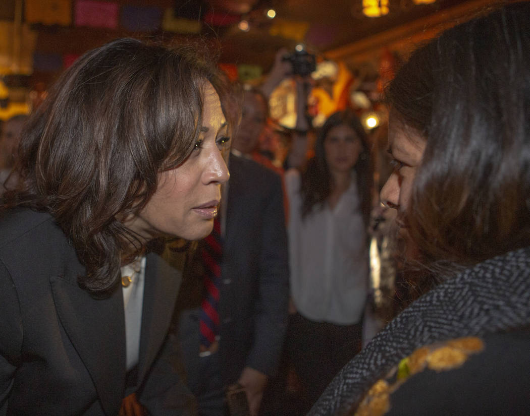 Democratic presidential candidate Sen. Kamala Harris, D-Calif., consoles Minerva Martinez, 47, ...