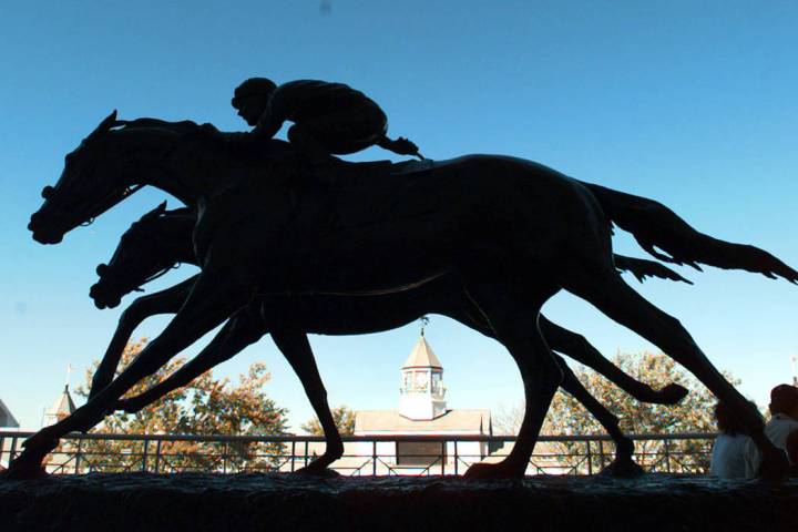 The two bronze horses in "Against All Odds" appears to be racing across the horizon of Arlingto ...