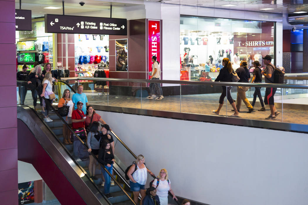 Passengers make their way to baggage claim and transportation at McCarran International Airport ...