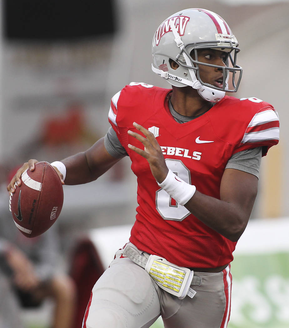 UNLV quarterback Caleb Herring looks for an open receiver against Wyoming at Sam Boyd Stadium i ...