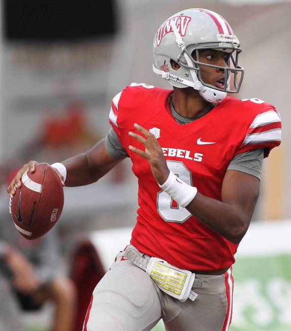 UNLV quarterback Caleb Herring looks for an open receiver against Wyoming at Sam Boyd Stadium i ...