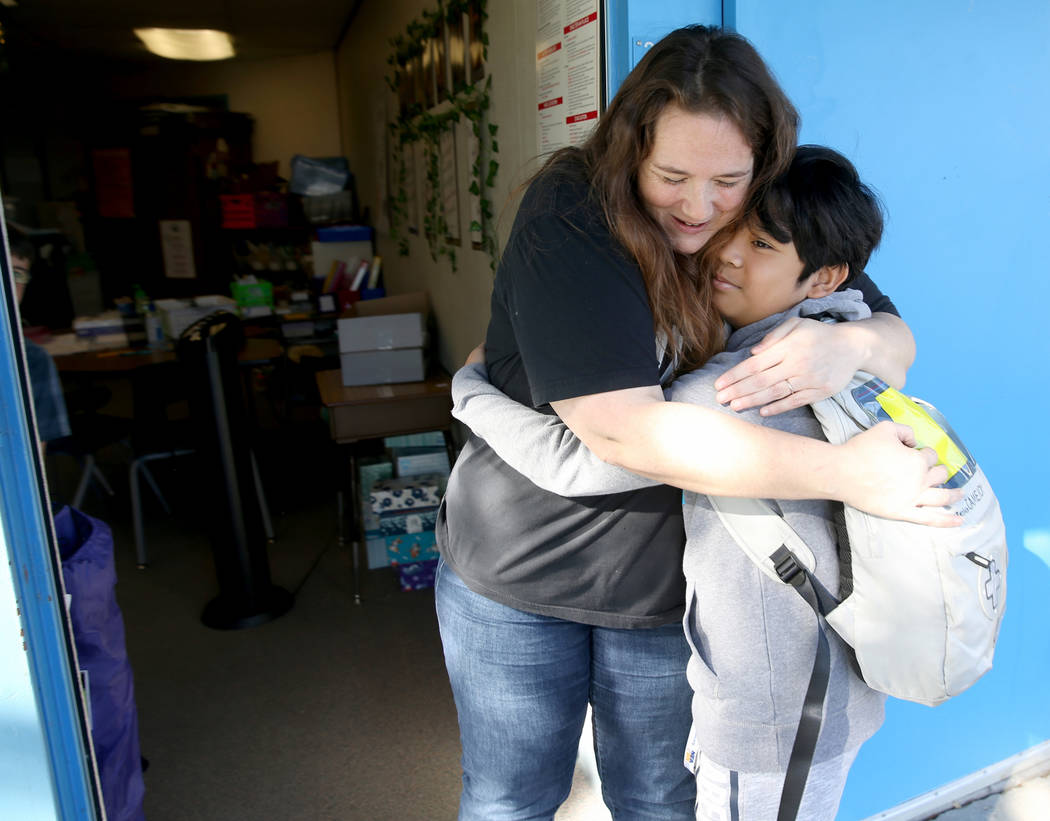 Helen Smith Elementary School fourth grade teacher Sarah Sunnasy gets a hug from fifth grader J ...