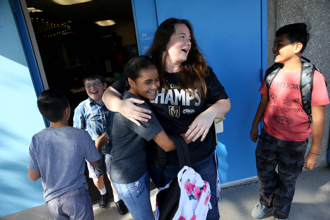 Helen Smith Elementary School fourth-grade teacher Sarah Sunnasy gets a hug from fifth-grader S ...