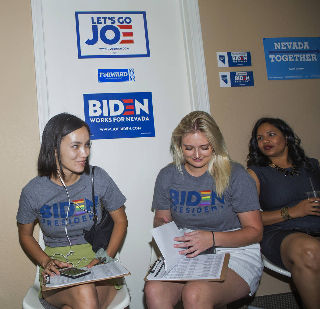 Joe Biden campaign staffers Mailinh McNicholas, left, Caroline Voelker, and Divya Narala wait f ...