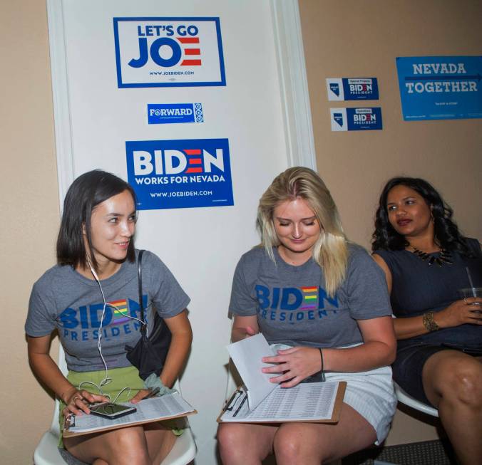 Joe Biden campaign staffers Mailinh McNicholas, left, Caroline Voelker, and Divya Narala wait f ...