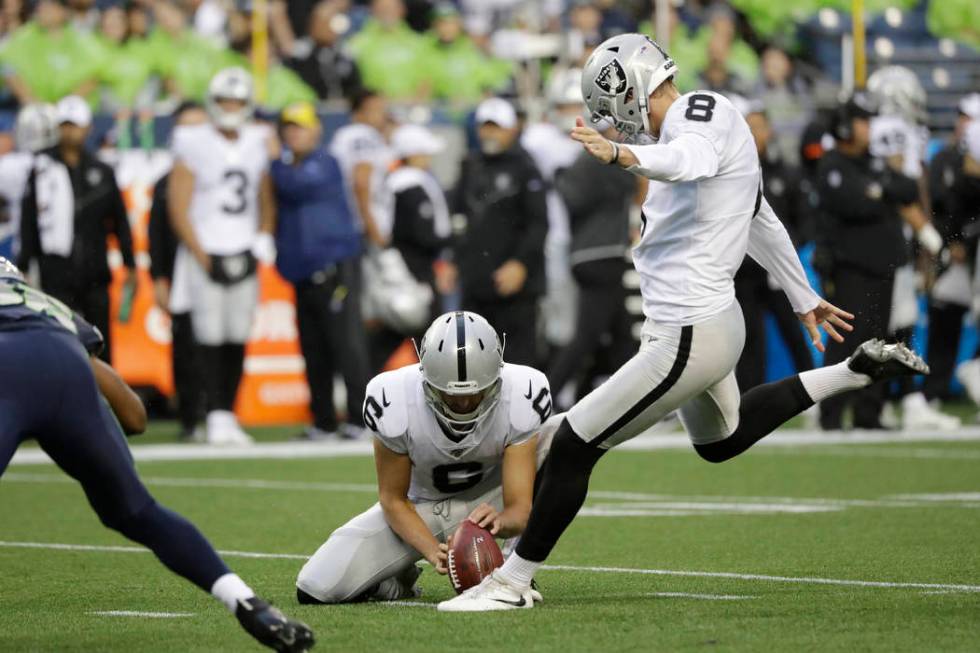 Oakland Raiders kicker Daniel Carlson (8) kicks a field goal as punter A.J. Cole holds during t ...