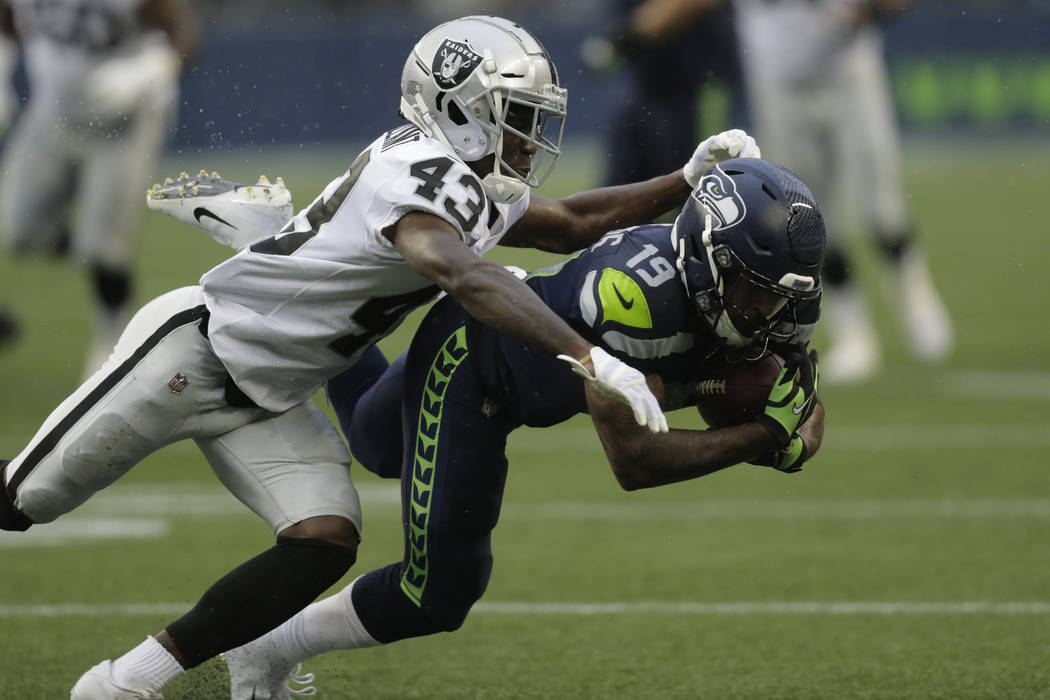 Oakland Raiders cornerback Makinton Dorleant (43) tackles wide receiver Keenan Reynolds (19) du ...