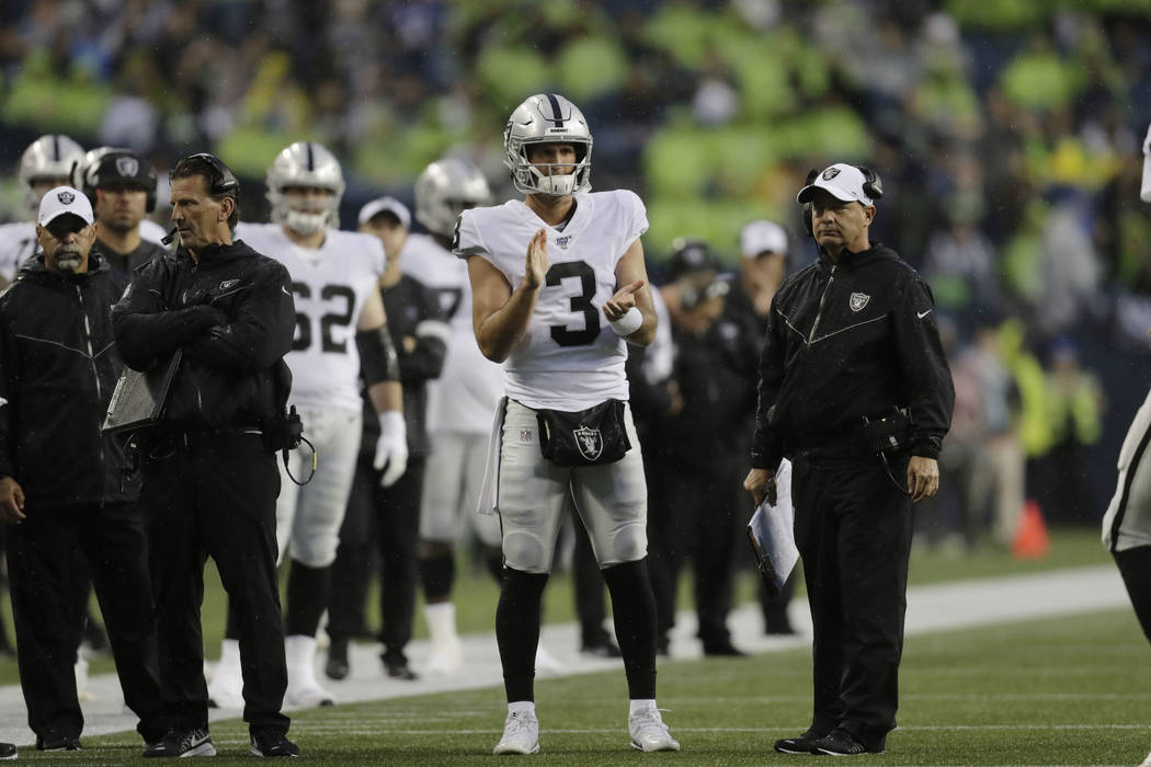 Oakland Raiders quarterback Nathan Peterman (3) stands with coaches during the first half of an ...