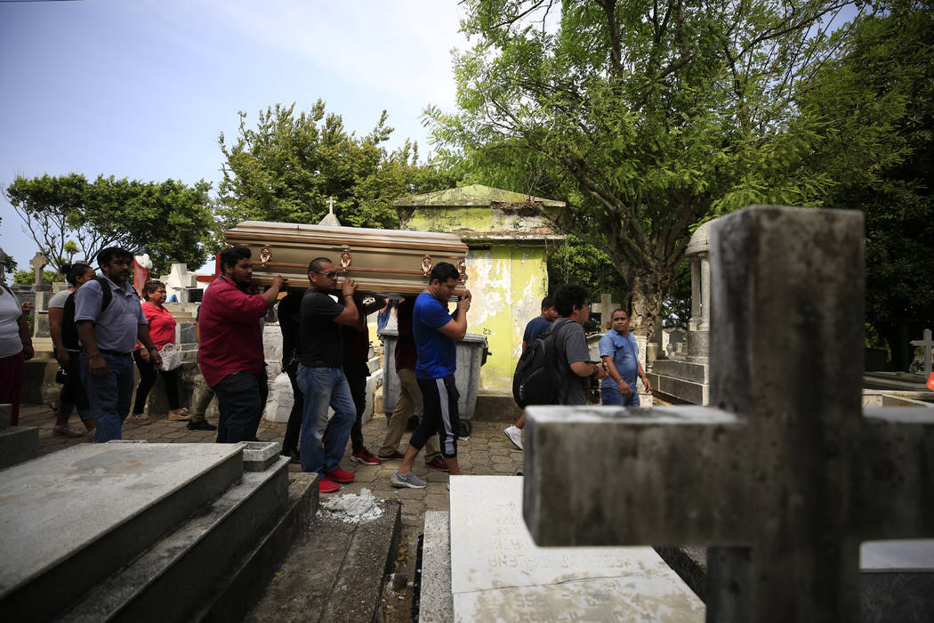 Mourners carry the coffin that contain the remains of Erick Hernandez Enriquez, also known as D ...