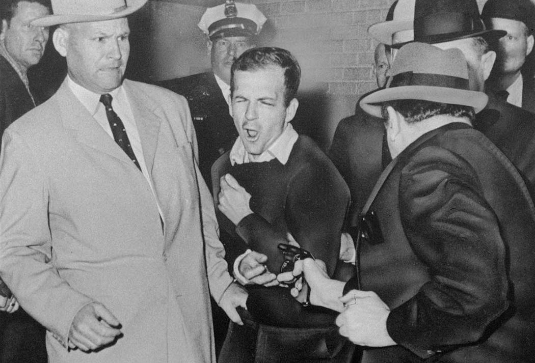 n this Nov. 24, 1963 file photo, Lee Harvey Oswald reacts as Dallas night club owner Jack Ruby, ...