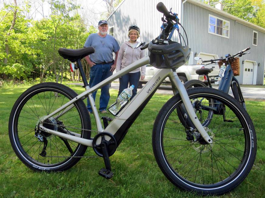 FILE-In this June 8, 2019 file photo, Gordon and Janice Goodwin show their electric-assist bicy ...