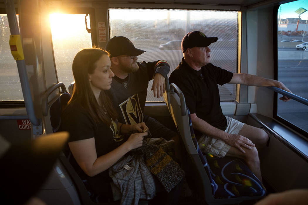 Hockey fans Trish Harrison, left, her husband Russ Harrison and Bill Smith ride an express bus ...