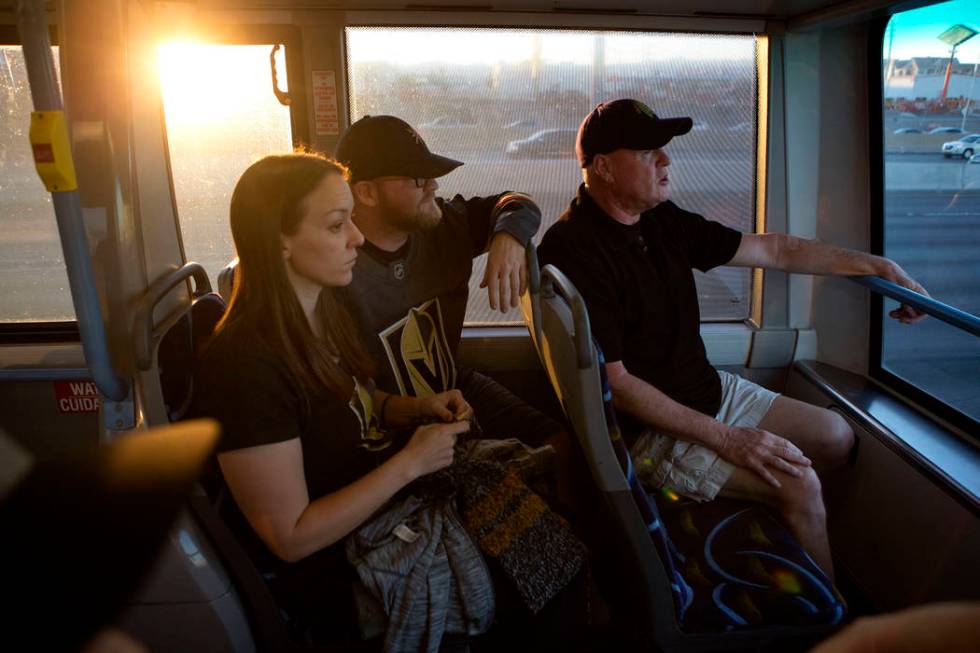 Hockey fans Trish Harrison, left, her husband Russ Harrison and Bill Smith ride an express bus ...