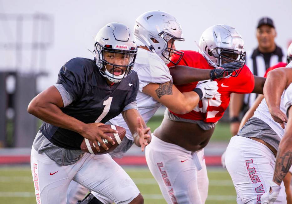 UNLV QB Armani Rogers (1) looks for room to run during their first major scrimmage of football ...