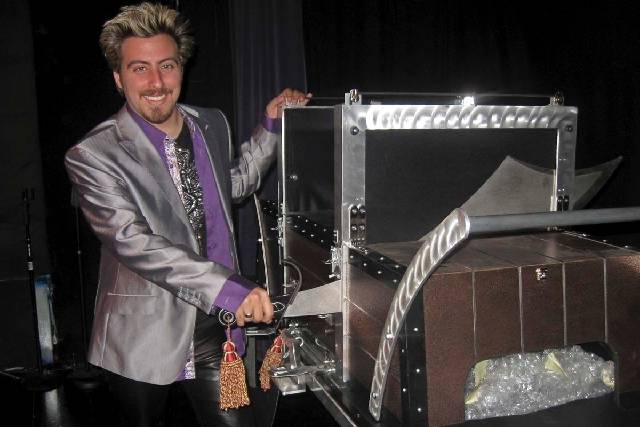 Master illusionist Tommy Wind demonstrates one of his magic tricks during an interview at the W ...