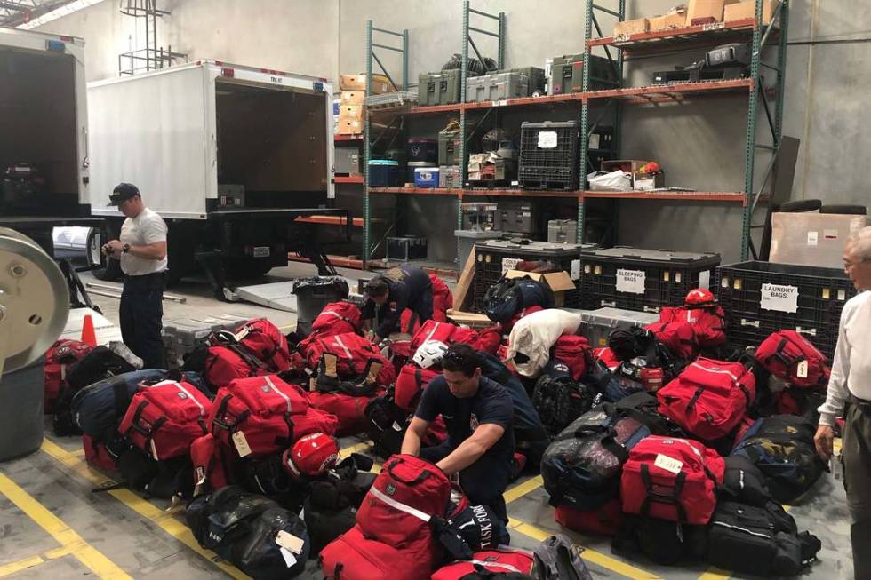 Members of Nevada Task Force One’s “Mission Ready Package — Water” prepare to leave Las ...