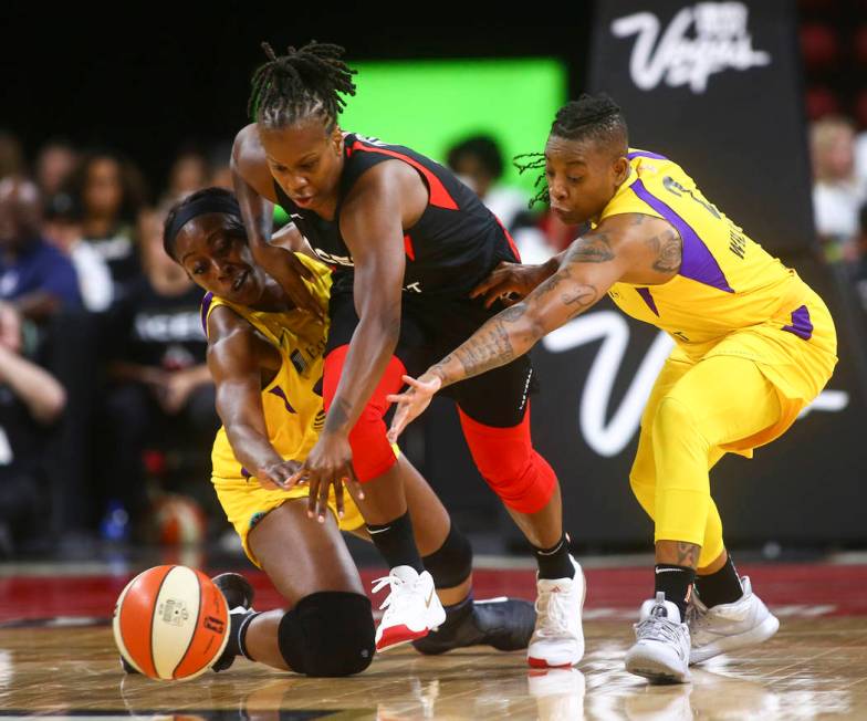 Las Vegas Aces' Epiphanny Prince battles for the ball between Los Angeles Sparks' Chiney Ogwumi ...