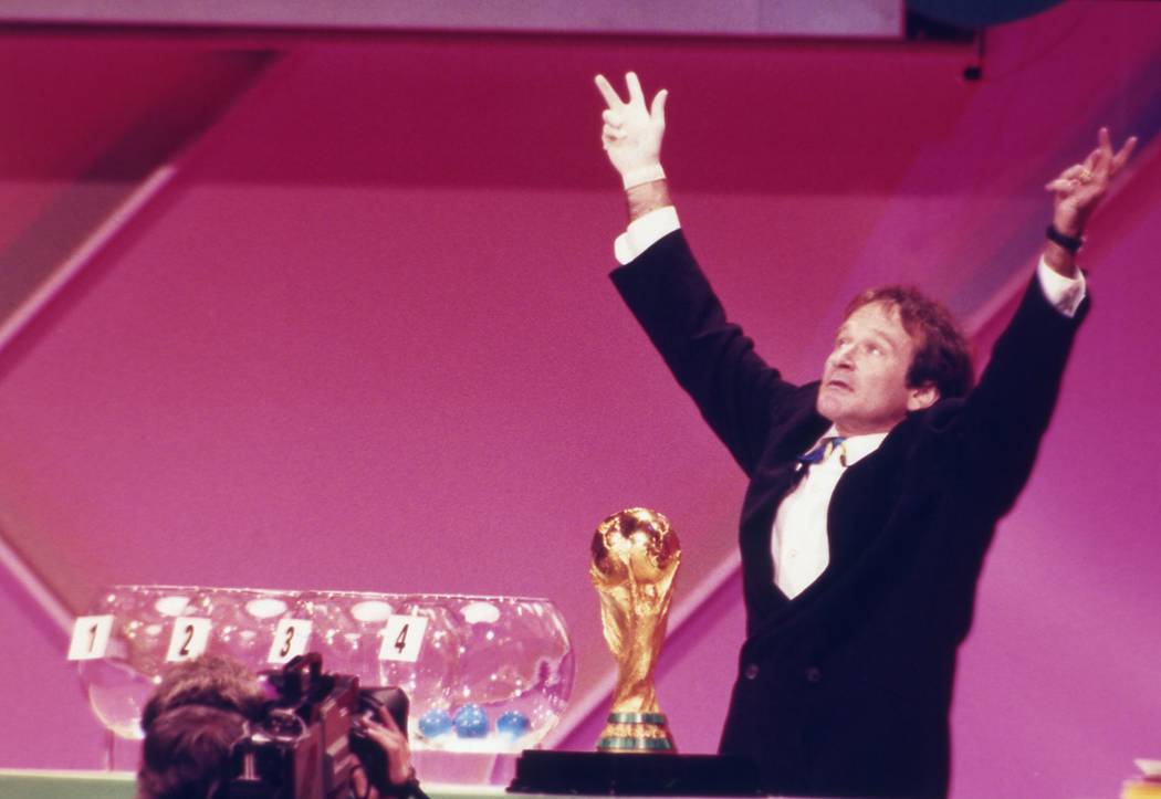 Actor Robin Williams holds up his arms after pulling Saudi Arabia's ball during the World Cup s ...