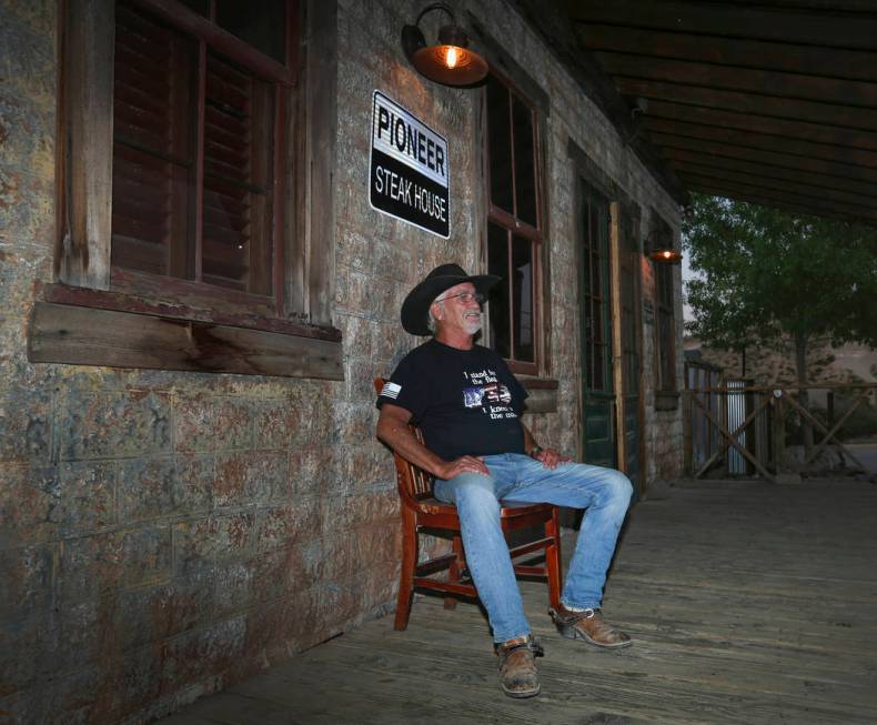 Jeff Humpres, 64, from Sandy Valley, relaxes on the front of the Pioneer Saloon in Goodsprings, ...
