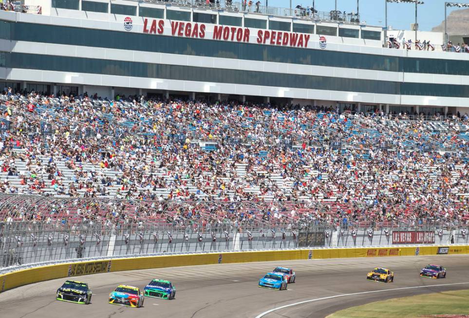 Race fans watch the South Point 400 NASCAR Cup Series auto race at the Las Vegas Motor Speedway ...