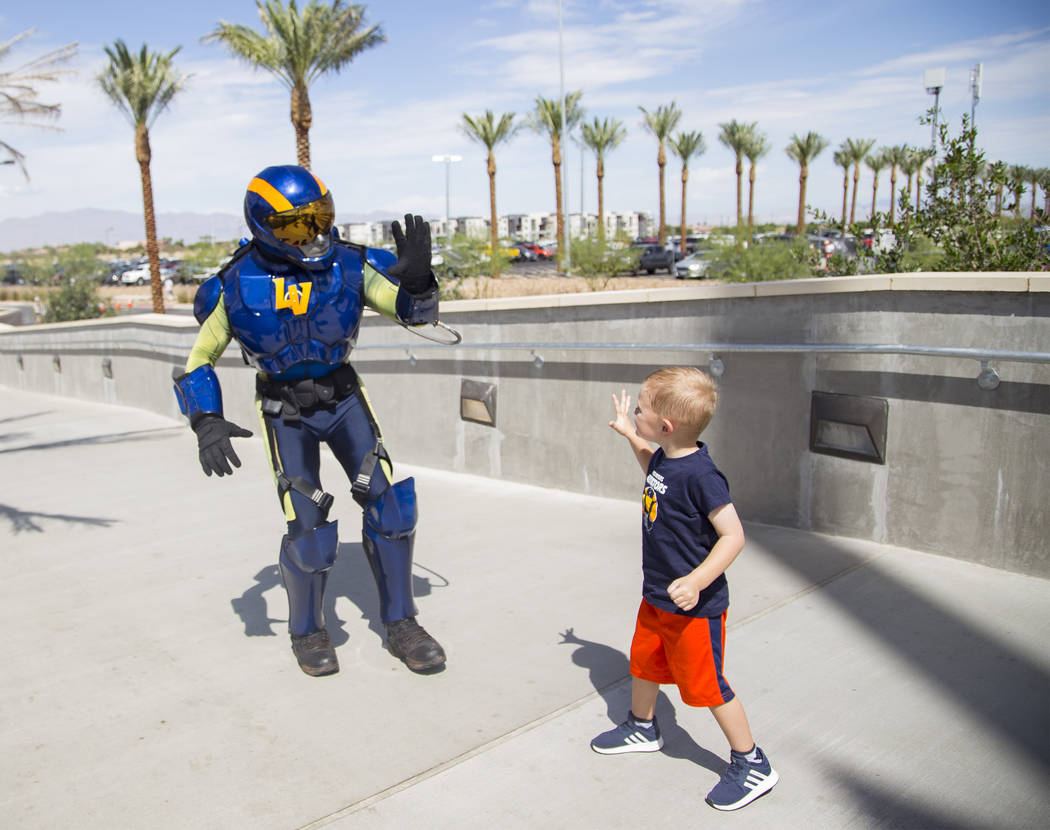 The Aviator mascot prepares to high-five Logan Like, 4, at the Las Vegas Ballpark in Downtown S ...