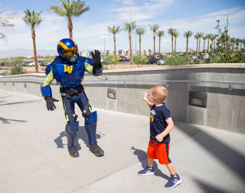 The Aviator mascot prepares to high-five Logan Like, 4, at the Las Vegas Ballpark in Downtown S ...