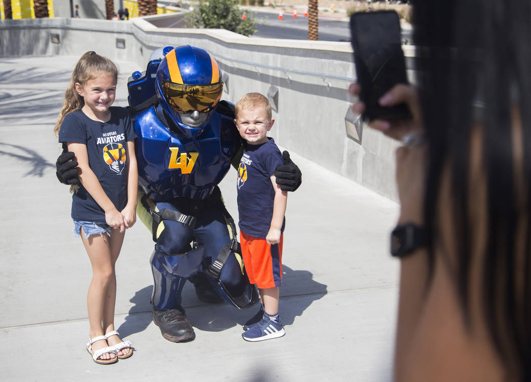 The Aviator mascot takes a photo with Logan Lyke, 4, and his sister Londyn Lyke, 6, at the Las ...