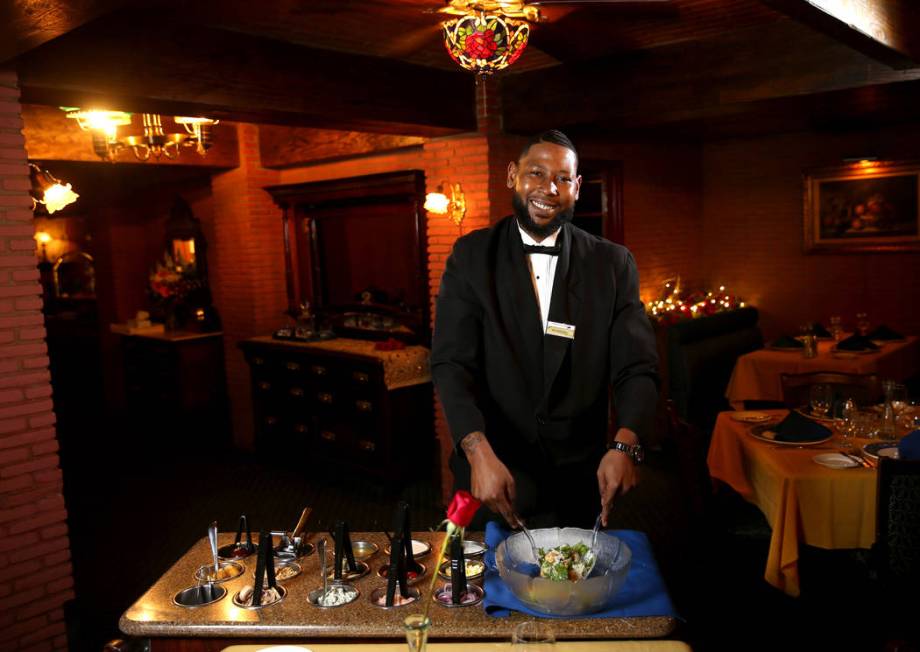 Rashard Miller, 36, of Las Vegas makes a Caesar salad tableside at Hugo's Cellar at Four Queens ...