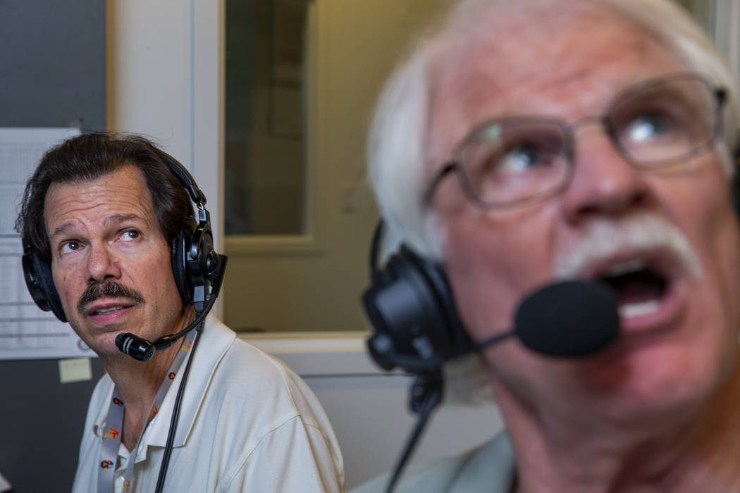 Russ Langer, left, looks on as Jerry Reuss commentates on a replay during their radio broadcast ...