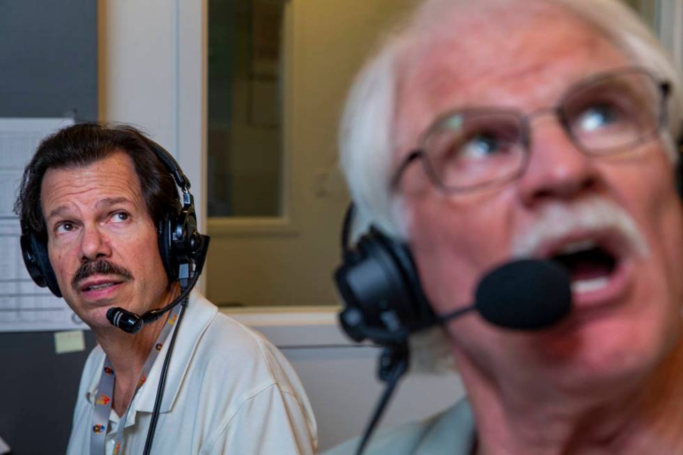 Russ Langer, left, looks on as Jerry Reuss commentates on a replay during their radio broadcast ...