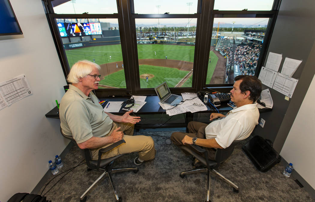 Jerry Reuss, left, and Russ Langer talk baseball on a break in their radio broadcast during the ...