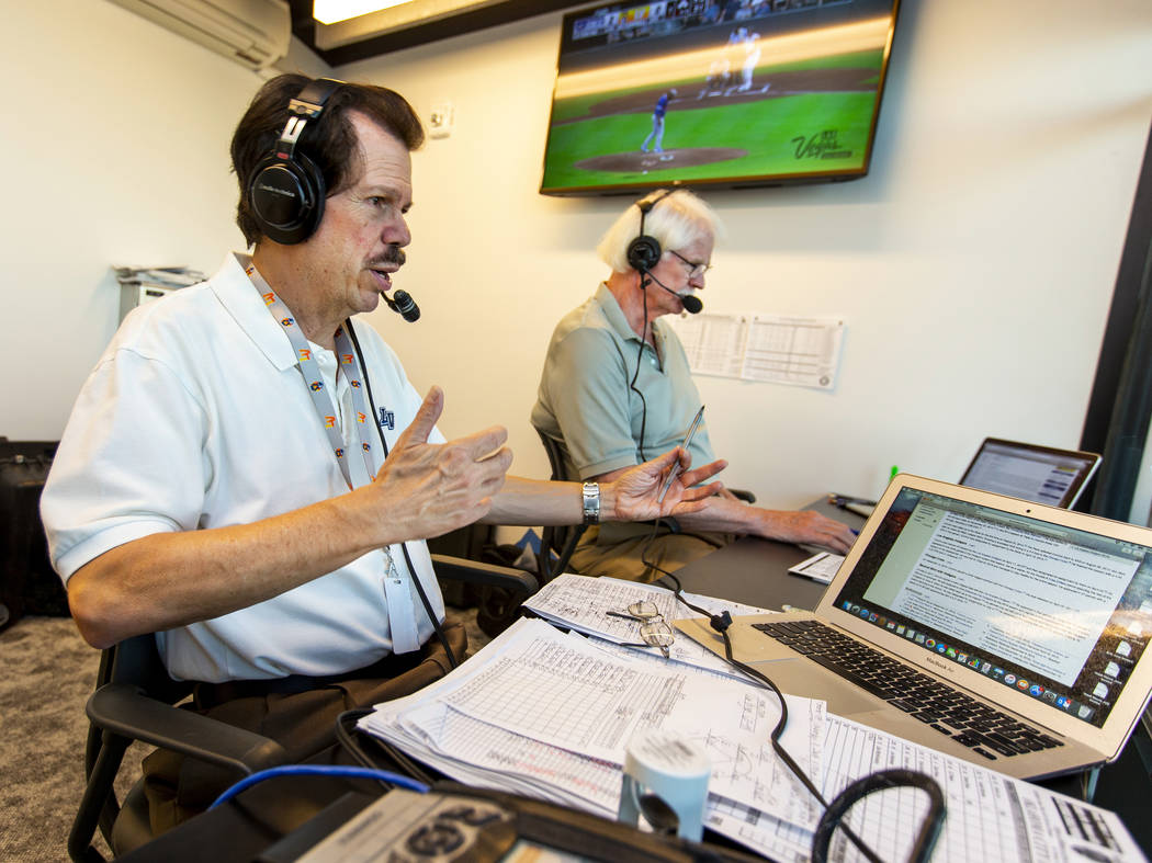 Russ Langer, left, commentates as Jerry Reuss checks some statistics during their radio broadca ...