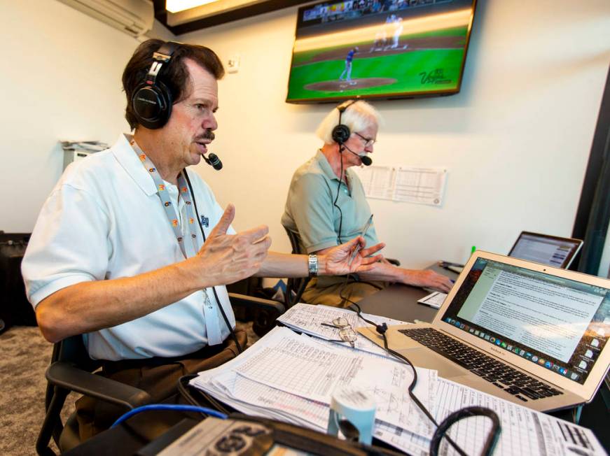 Russ Langer, left, commentates as Jerry Reuss checks some statistics during their radio broadca ...