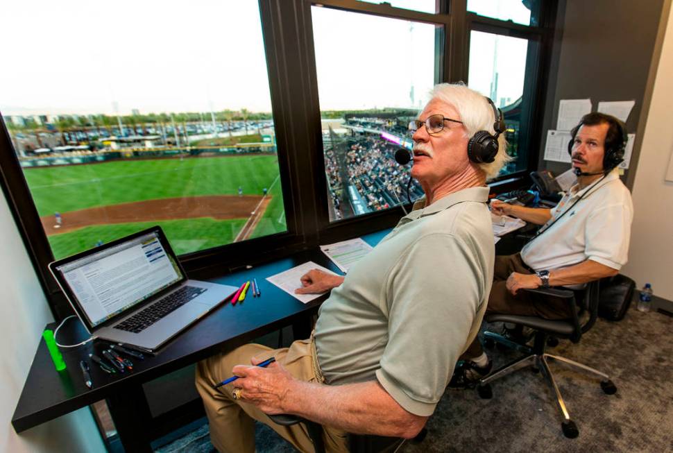 Jerry Reuss, left, and Russ Langer look to a video replay for their radio broadcast during the ...