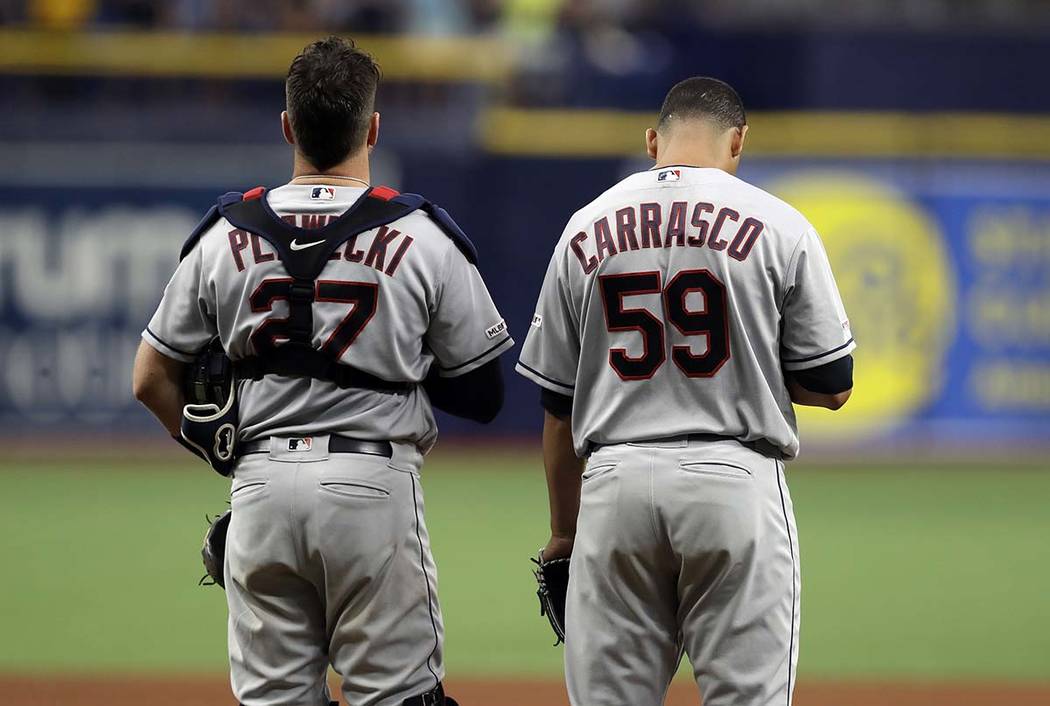 Cleveland Indians pitcher Carlos Carrasco (59) stands with catcher Kevin Plawecki during the pl ...