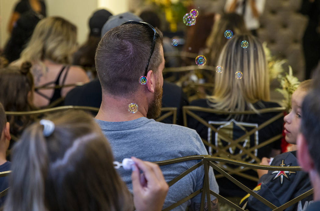 Bubbles are blown by a young guests as Vegas Golden Knights player Ryan Reaves conducts a marri ...