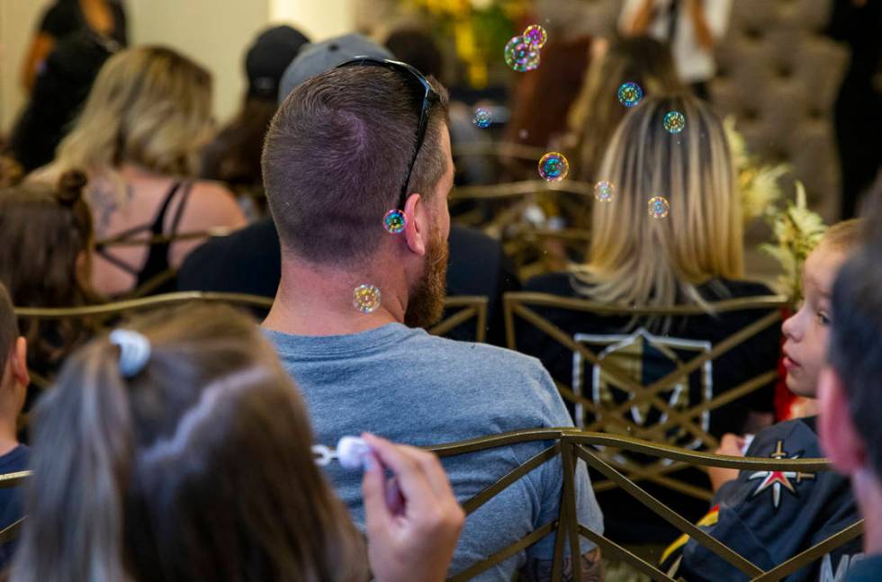 Bubbles are blown by a young guests as Vegas Golden Knights player Ryan Reaves conducts a marri ...