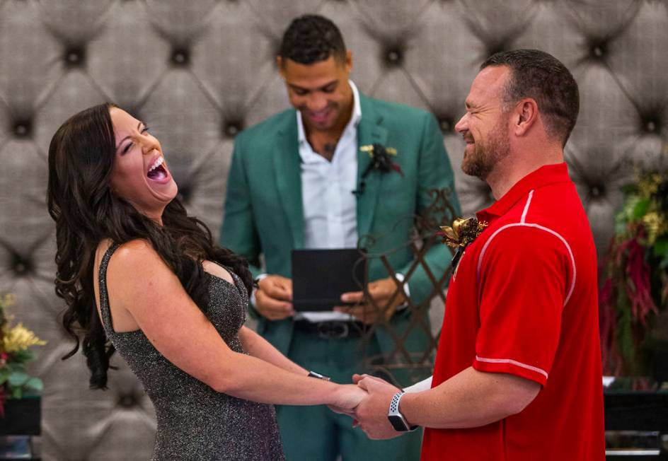 Laura and Justin Long hold hands and laugh as Vegas Golden Knights player Ryan Reaves, center, ...