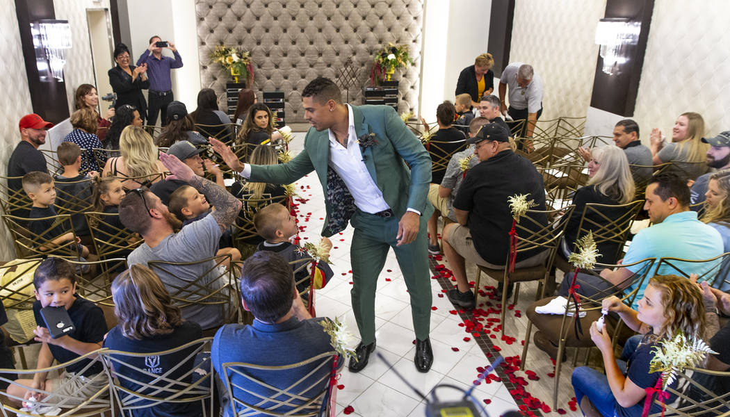 Vegas Golden Knights player Ryan Reaves walks back down the aisle giving out "high fives&q ...