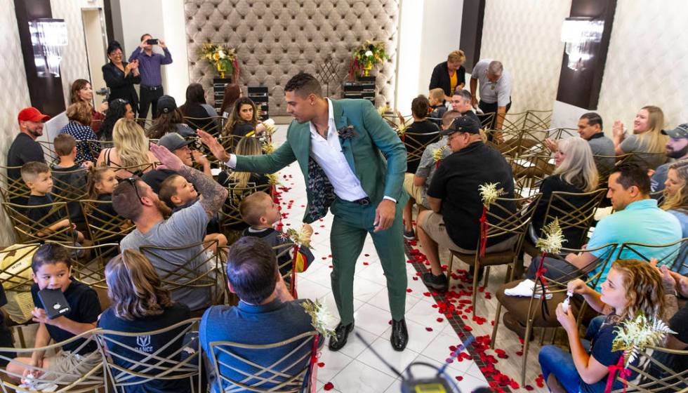 Vegas Golden Knights player Ryan Reaves walks back down the aisle giving out "high fives&q ...