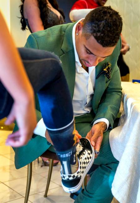 Vegas Golden Knights player Ryan Reaves autographs a sneaker for a guest after conducting a mar ...