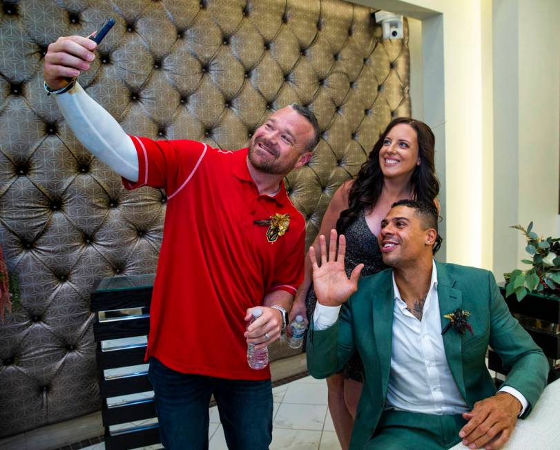 (From left) Justin and Laura Long join Vegas Golden Knights player Ryan Reaves in a quick messa ...