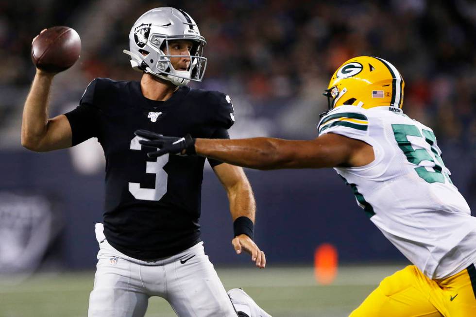 Oakland Raiders quarterback Nathan Peterman (3) throws as Green Bay Packers' Markus Jones (59) ...