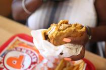 Janine Blake, of Las Vegas, eats her spicy chicken sandwich at Popeyes on the corner of Bonanza ...